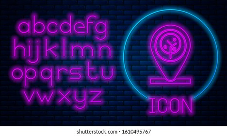 Glowing neon Location and tree icon isolated on brick wall background. Neon light alphabet. Vector Illustration