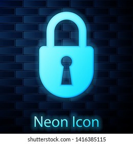 Glowing neon Lock icon isolated on brick wall background. Padlock sign. Security, safety, protection, privacy concept. Vector Illustration