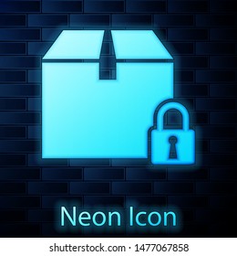 Glowing neon Locked package icon isolated on brick wall background. Lock and cardboard box.  Vector Illustration