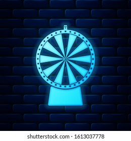 Glowing neon Lucky wheel icon isolated on brick wall background.  Vector Illustration