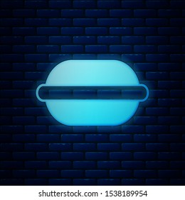 Glowing neon Macaron cookie icon isolated on brick wall background. Macaroon sweet bakery.  Vector Illustration