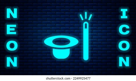 Glowing neon Magic hat and wand icon isolated on brick wall background. Magic trick. Mystery entertainment concept.  Vector