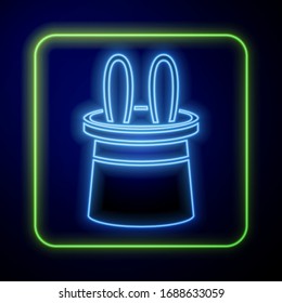 Glowing neon Magician hat and rabbit ears icon isolated on blue background. Magic trick. Mystery entertainment concept.  Vector Illustration