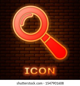 Glowing neon Magnifying glass icon isolated on brick wall background. Search, focus, zoom, business symbol.  Vector Illustration