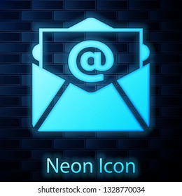 Glowing neon Mail and e-mail icon isolated on brick wall background. Envelope symbol e-mail. Email message sign. Vector Illustration
