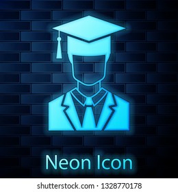 Glowing neon Male graduate student profile with gown and graduation cap icon isolated on brick wall background. Vector Illustration