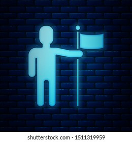 Glowing neon Man holding flag icon isolated on brick wall background.  Vector Illustration