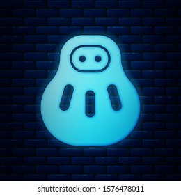 Glowing neon Maneki neko cat icon isolated on brick wall background. Japan lucky charm.  Vector Illustration