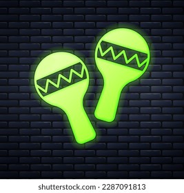 Glowing neon Maracas icon isolated on brick wall background. Music maracas instrument mexico.  Vector
