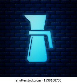 Glowing neon Measuring cup to measure dry and liquid food icon isolated on brick wall background. Plastic graduated beaker with handle.  Vector Illustration