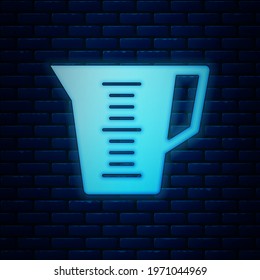 Glowing neon Measuring cup to measure dry and liquid food icon isolated on brick wall background. Plastic graduated beaker with handle.  Vector