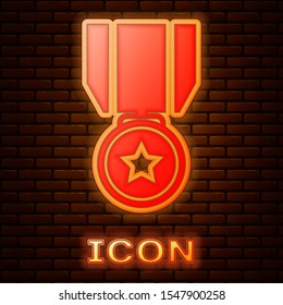 Glowing neon Medal with star icon isolated on brick wall background. Winner achievement sign. Award medal.  Vector Illustration