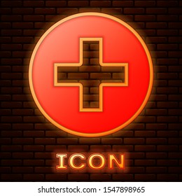 Glowing neon Medical cross in circle icon isolated on brick wall background. First aid medical symbol.  Vector Illustration