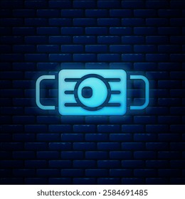 Glowing neon Medical protective mask icon isolated on brick wall background.  Vector