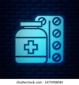 Glowing neon Medicine bottle and pills icon isolated on brick wall background. Bottle pill sign. Pharmacy design.  Vector Illustration