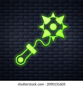 Glowing neon Medieval chained mace ball icon isolated on brick wall background. Morgenstern medieval weapon or mace with spikes.  Vector