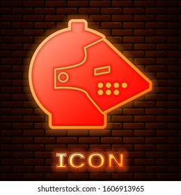 Glowing neon Medieval iron helmet for head protection icon isolated on brick wall background.  Vector Illustration