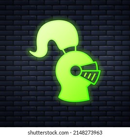 Glowing neon Medieval iron helmet for head protection icon isolated on brick wall background. Knight helmet.  Vector