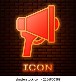 Glowing neon Megaphone icon isolated on brick wall background. Speaker sign.  Vector