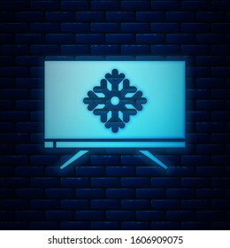 Glowing neon Merry Christmas on television and snowflake icon isolated on brick wall background. Happy New Year.  Vector Illustration