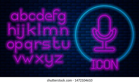 Glowing neon Microphone icon isolated on brick wall background. On air radio mic microphone. Speaker sign. Neon light alphabet. Vector Illustration