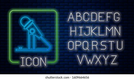 Glowing neon Microphone icon isolated on brick wall background. On air radio mic microphone. Speaker sign. Neon light alphabet. Vector Illustration