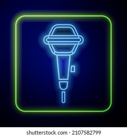 Glowing neon Microphone icon isolated on blue background. On air radio mic microphone. Speaker sign.  Vector