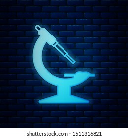 Glowing neon Microscope icon isolated on brick wall background. Chemistry, pharmaceutical instrument, microbiology magnifying tool.  Vector Illustration