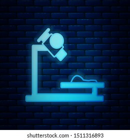 Glowing neon Microscope icon isolated on brick wall background. Chemistry, pharmaceutical instrument, microbiology magnifying tool.  Vector Illustration