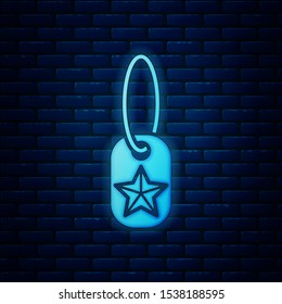 Glowing neon Military dog tag icon isolated on brick wall background. Identity tag icon. Army sign.  Vector Illustration