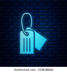 Glowing neon Military dog tag icon isolated on brick wall background. Identity tag icon. Army sign.  Vector Illustration