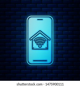 Glowing neon Mobile phone with smart home with wi-fi icon isolated on brick wall background. Remote control.  Vector Illustration