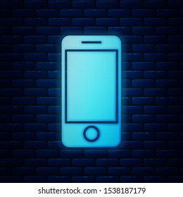 Glowing neon Mobile smart phone with app delivery tracking icon isolated on brick wall background. Parcel tracking.  Vector Illustration