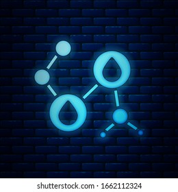 Glowing neon Molecule oil icon isolated on brick wall background. Structure of molecules in chemistry.  Vector Illustration