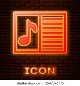 Glowing neon Music book with note icon isolated on brick wall background. Music sheet with note stave. Notebook for musical notes.  Vector Illustration