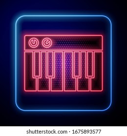 Glowing neon Music synthesizer icon isolated on blue background. Electronic piano.  Vector Illustration