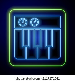 Glowing neon Music synthesizer icon isolated on blue background. Electronic piano.  Vector