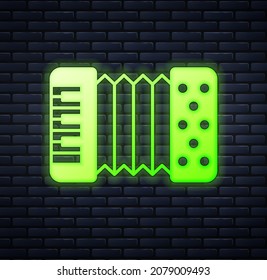 Glowing neon Musical instrument accordion icon isolated on brick wall background. Classical bayan, harmonic.  Vector