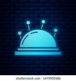Glowing neon Needle bed and needles icon isolated on brick wall background. Handmade and sewing theme.  Vector Illustration