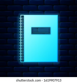 Glowing neon Notebook icon on brick wall background. Spiral notepad icon. School notebook. Writing pad. Diary for business. Notebook cover design. Office stationery items.  Vector Illustration