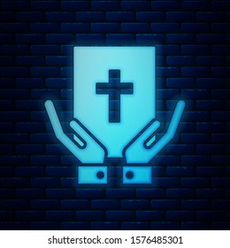Glowing neon Oath on the Holy Bible icon isolated on brick wall background. The procedure in court. Truth and truth. Promise before god.  Vector Illustration