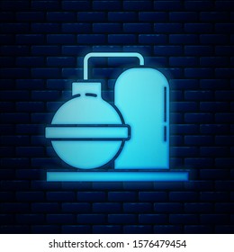 Glowing neon Oil and gas industrial factory building icon isolated on brick wall background.  Vector Illustration