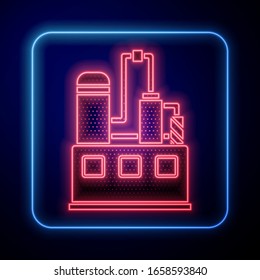 Glowing neon Oil and gas industrial factory building icon isolated on blue background.  Vector Illustration
