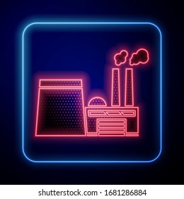 Glowing neon Oil and gas industrial factory building icon isolated on blue background.  Vector Illustration