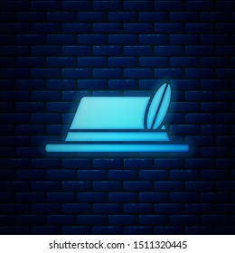 Glowing neon Oktoberfest hat icon isolated on brick wall background. Hunter hat with feather. German hat.  Vector Illustration