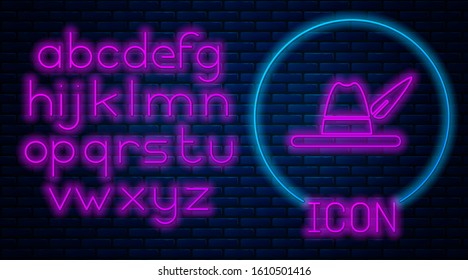 Glowing neon Oktoberfest hat icon isolated on brick wall background. Hunter hat with feather. German hat. Neon light alphabet. Vector Illustration