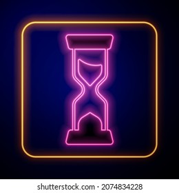Glowing neon Old hourglass with flowing sand icon isolated on black background. Sand clock sign. Business and time management concept.  Vector
