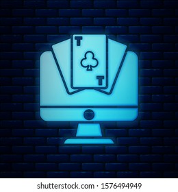 Glowing neon Online poker table game icon isolated on brick wall background. Online casino.  Vector Illustration