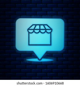 Glowing neon Online shopping concept. Buy on screen laptop icon isolated on brick wall background. Concept e-commerce, online business marketing.  Vector Illustration