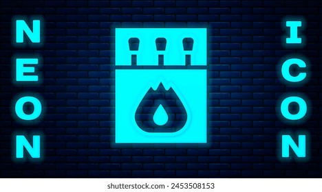 Glowing neon Open matchbox and matches icon isolated on brick wall background.  Vector